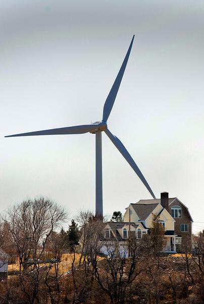 One of Hull’s two land wind turbines is on a former landfill, towering over Orleans Street. GREG DERR/The Patriot Ledger 