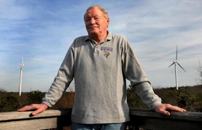 Barry Funfar on the deck of his home, near the turbines.